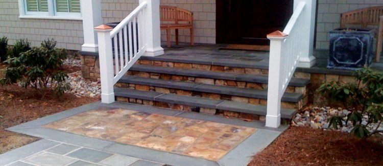 beautiful stone porch with white railing