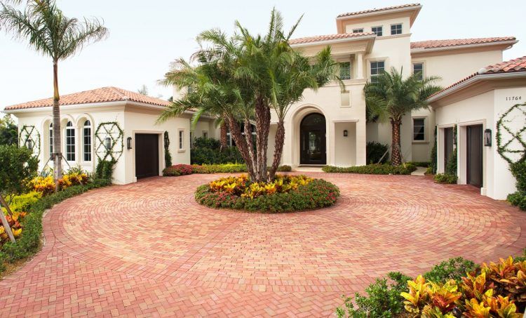 luxurious home with large circular brick driveway