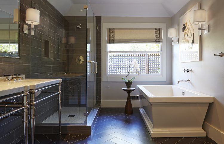 bathroom with glass enclosed shower and square tub