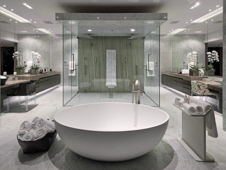 large modern bathroom with glass shower and round tub