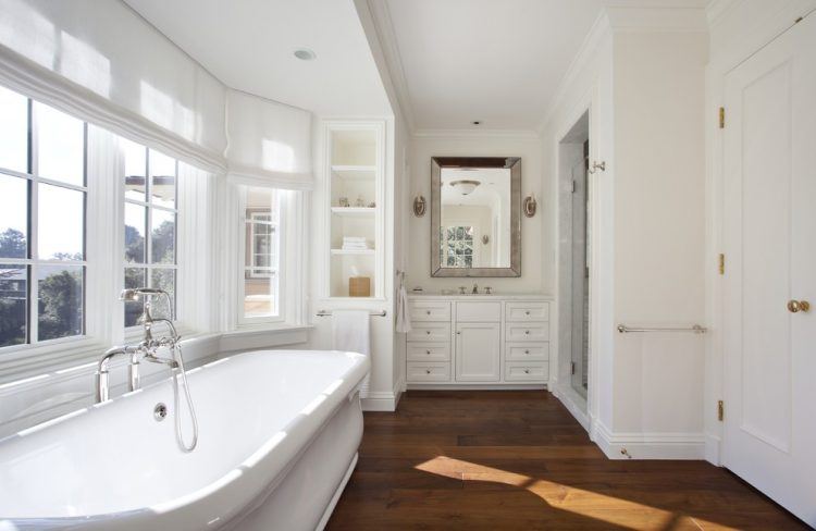 all white bathroom with hardwood flooring