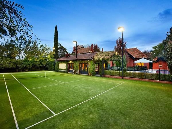 beautiful grass tennis court behind home