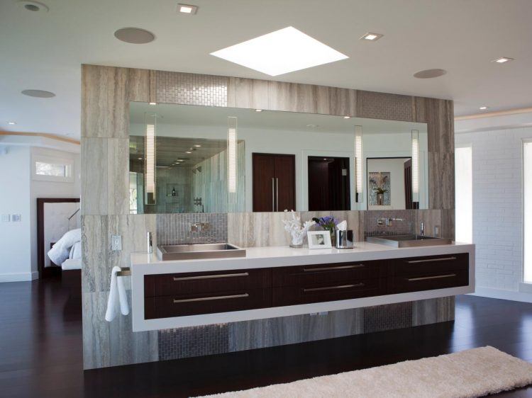 bathroom with long mirror and gray vanity