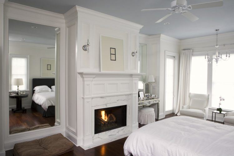 bedroom with large white fireplace