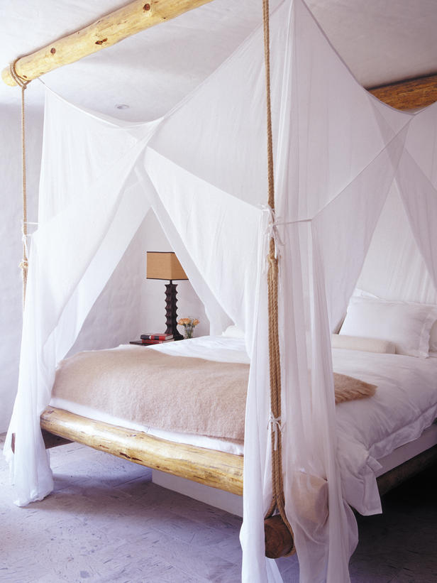 home made canopy bed with white curtains