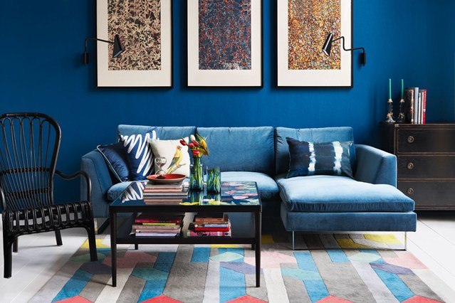 living room with blue sections sofa and blue walls