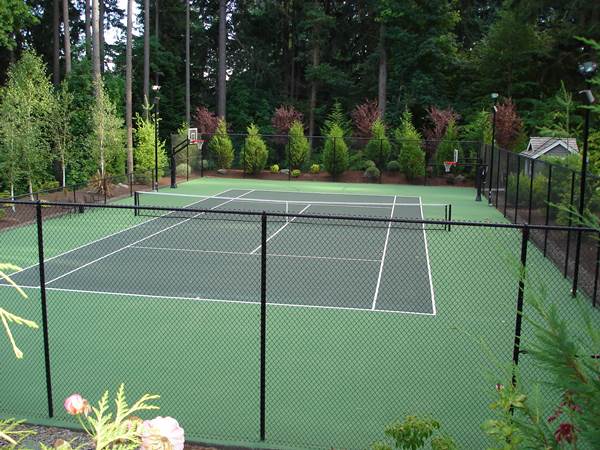 fenced in tennis court with basketball hoop