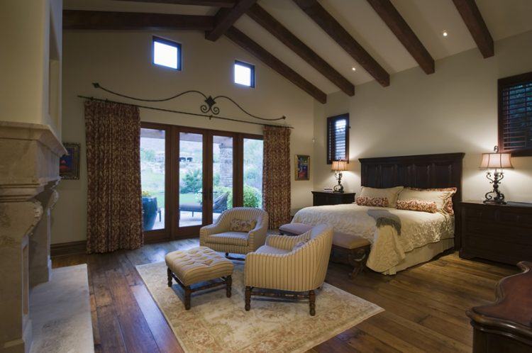 bedroom-with-vaulted-ceiling-exposed-beams-large-wood-headboard