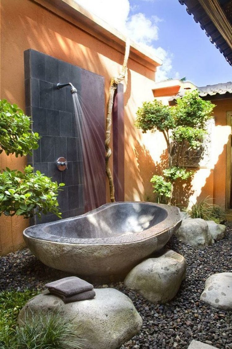 beautiful outdoor shower and stone tub