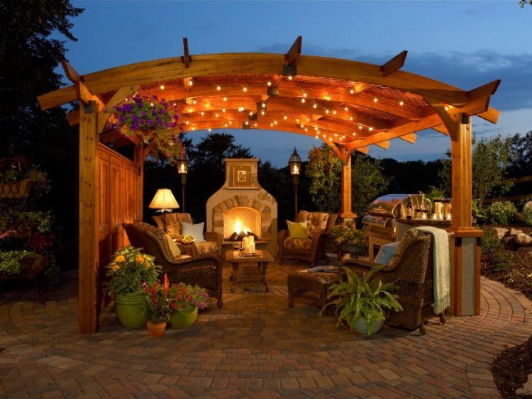 outdoor entertainment area with open fireplace and furniture