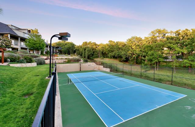 blue and green tennis court with lights