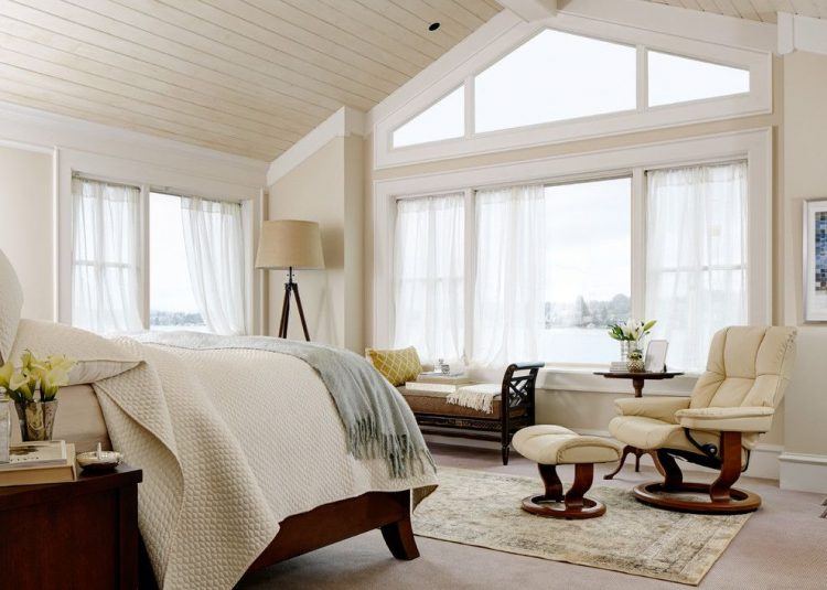 beige bedroom with large windows