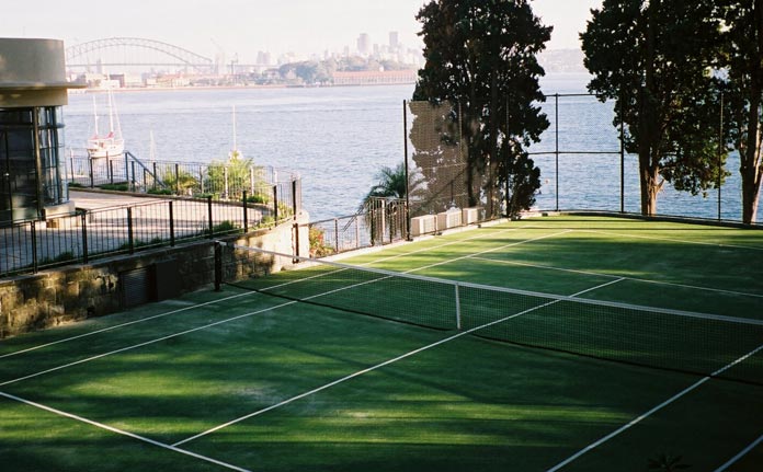 beautiful tennis court next to the water