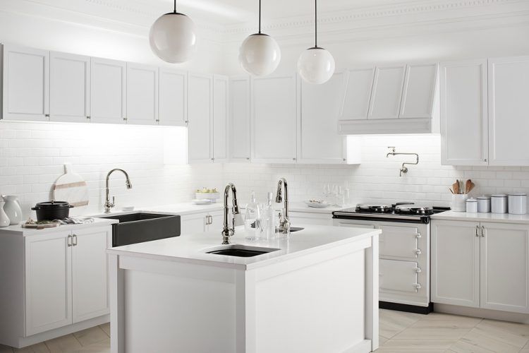 all white kitchen with round hanging lamps