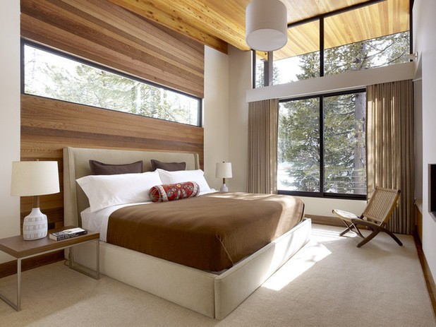 contemporary bedroom with window above bed