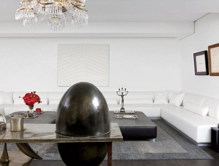 white living room with crystal chandelier 