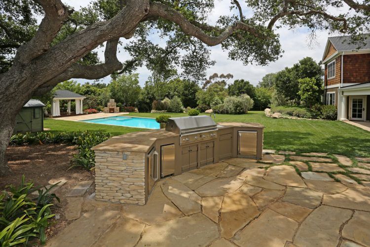 outdoor cooking area with swimming pool