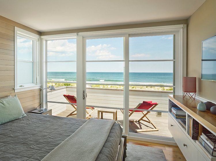 beach style bedroom with large windows