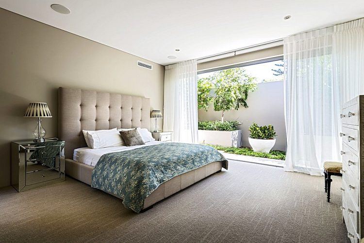 contemporary master bedroom with large window