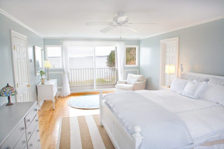 beautiful coastal bedroom with wood flooring