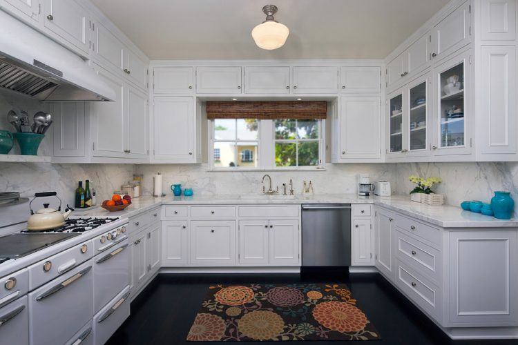 kitchen-traditional-with-dark-floor-glass-front-cabinets-kitchen-rug-schoolhouse-sconce-stainless-steel-appliances