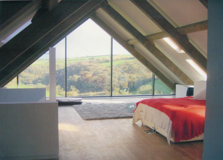 beautiful attic style bedroom with triangle window