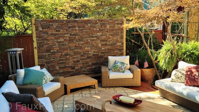 comfortable patio area with brick wall