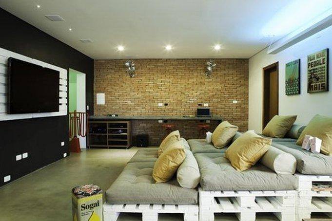 basement living room with brick wall