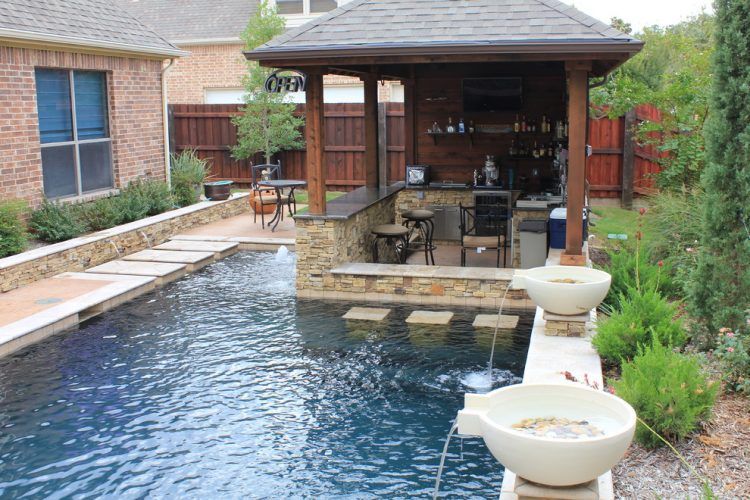 traditional backyard swimming pool with fountains