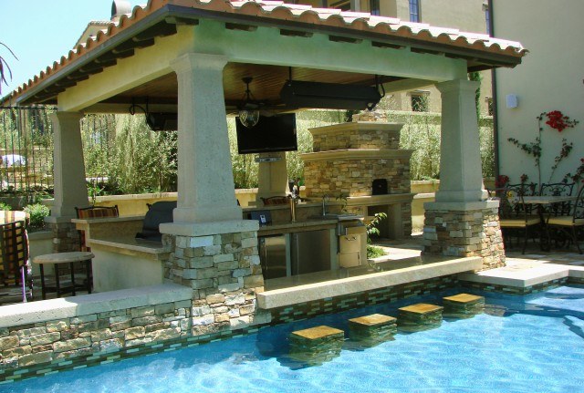 outdoor cooking space with swim up bar