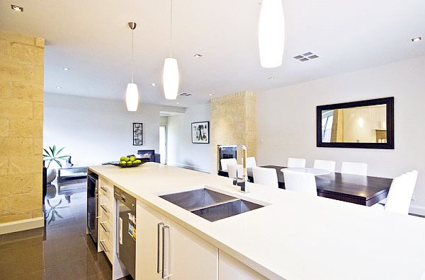 white kitchen with long hanging lamps