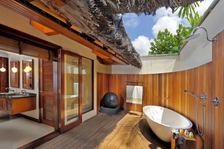 beautiful tropical style bathroom with freestanding tub