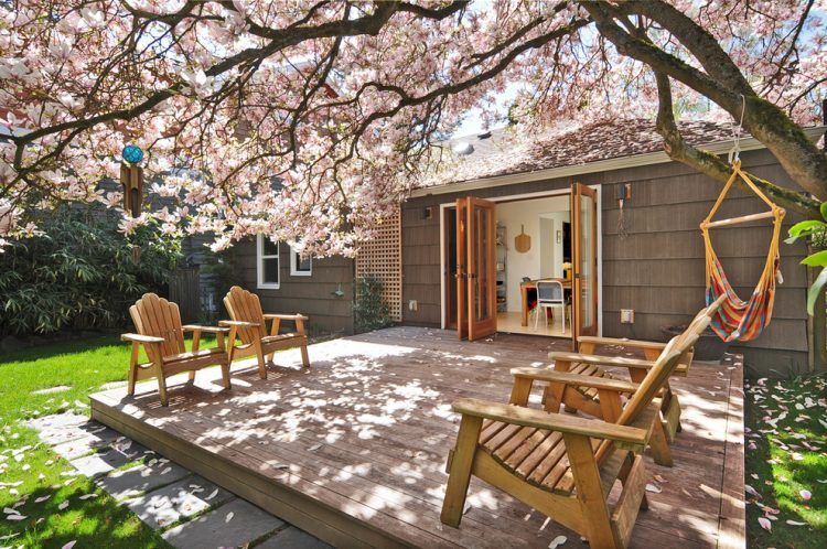 backyard deck area with wooden chairs