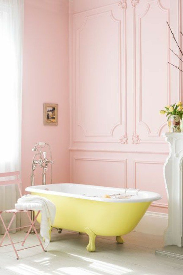 pink bathroom with bright yellow tub