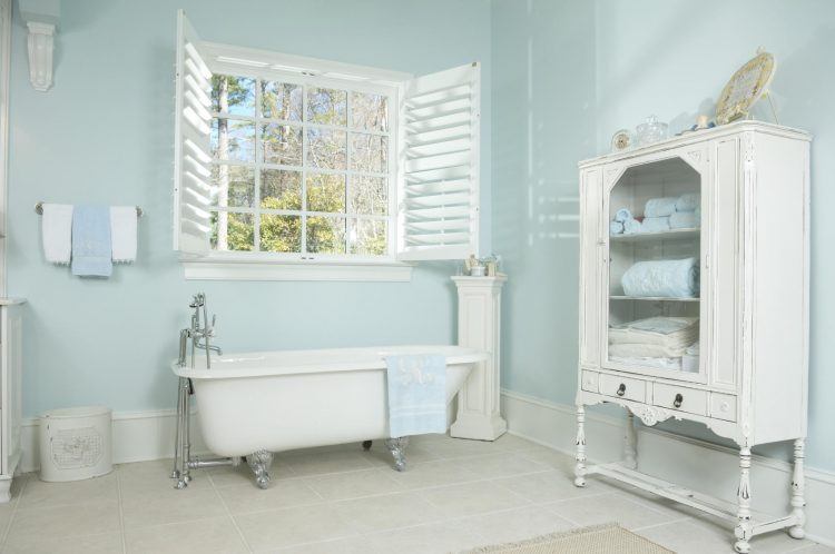 light blue bathroom with white cabinet