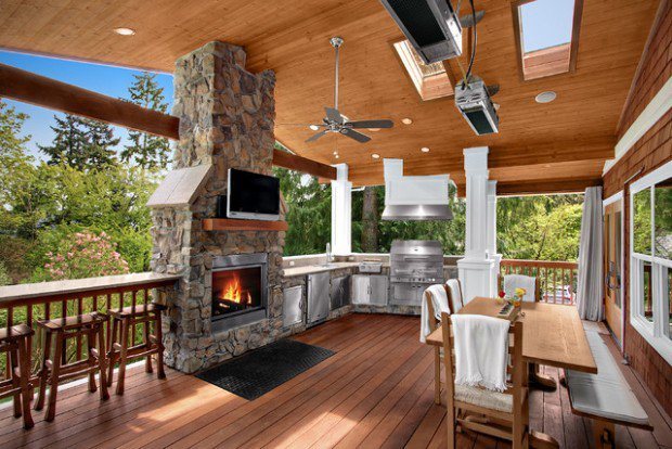 covered deck with stone fireplace