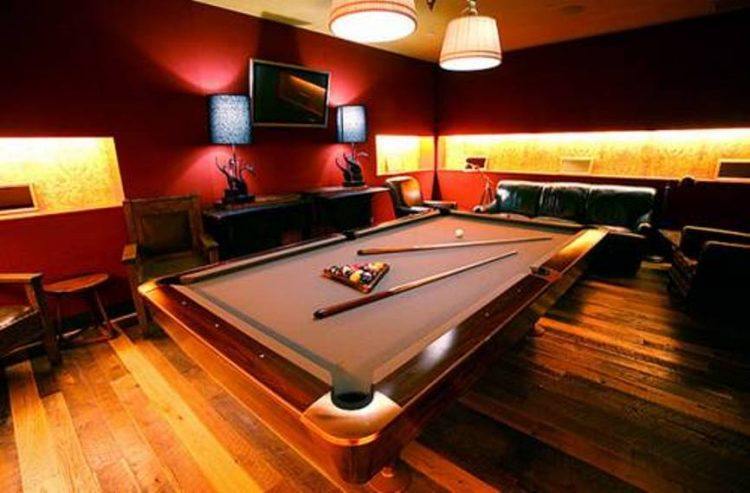 pool room at home with hardwood flooring