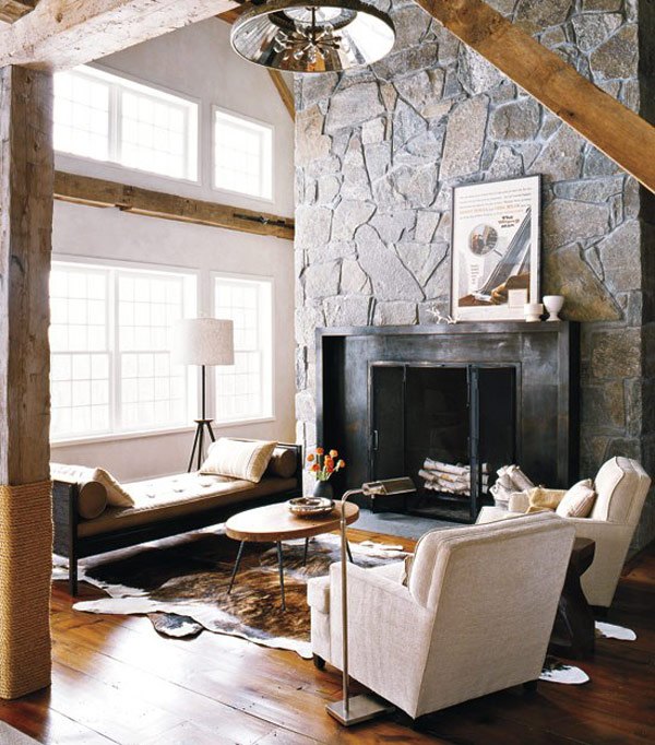 living room with stone wall and fireplace