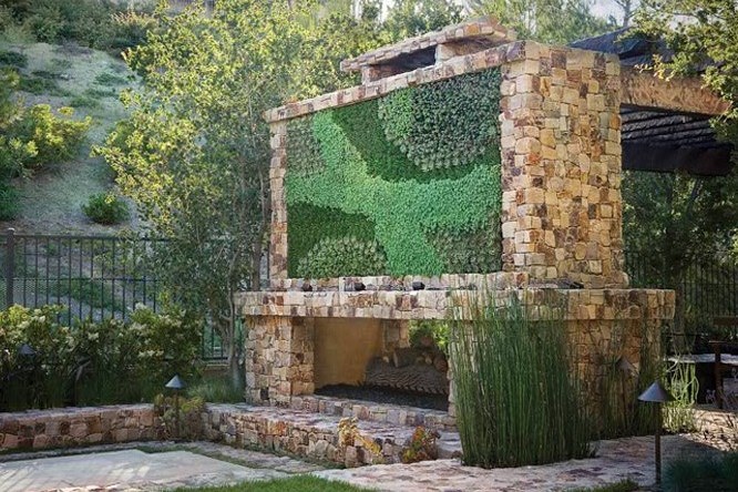 stone fireplace with large green wall