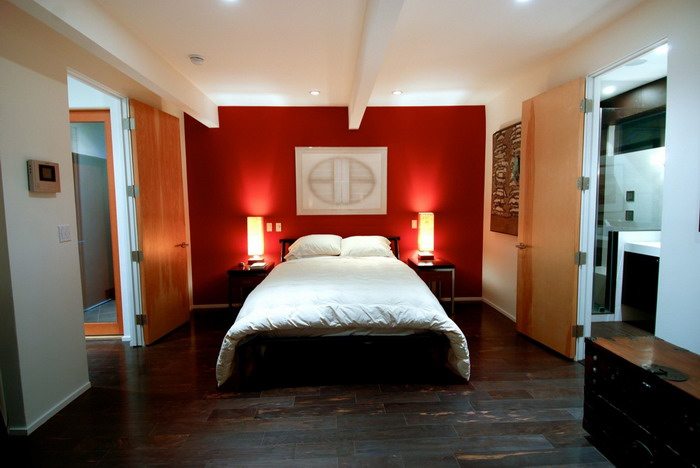 master bedroom with red accent wall