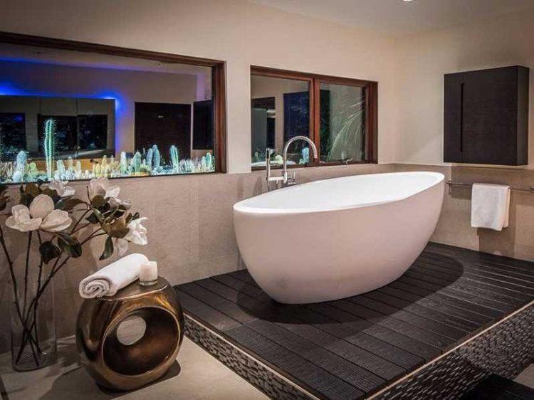 freestanding bathtub on black platform