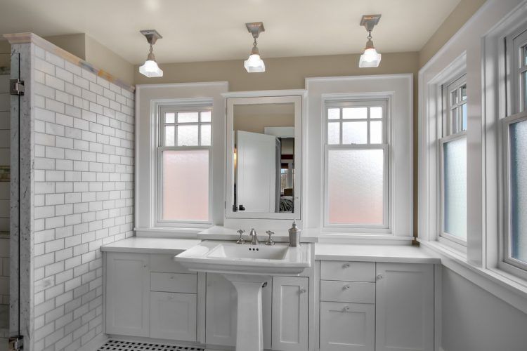 all white bathroom with hanging lamps