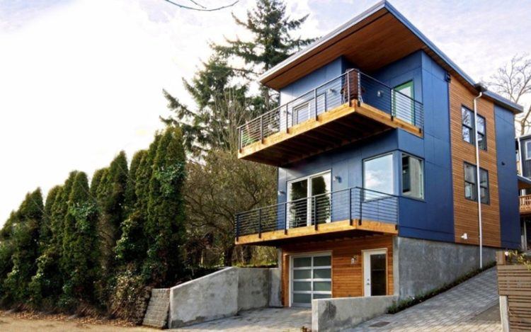 beautiful blue home with balconies
