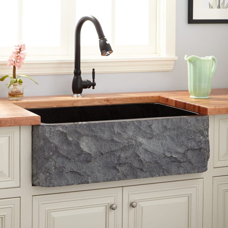 beautiful stone kitchen with wooden countertop