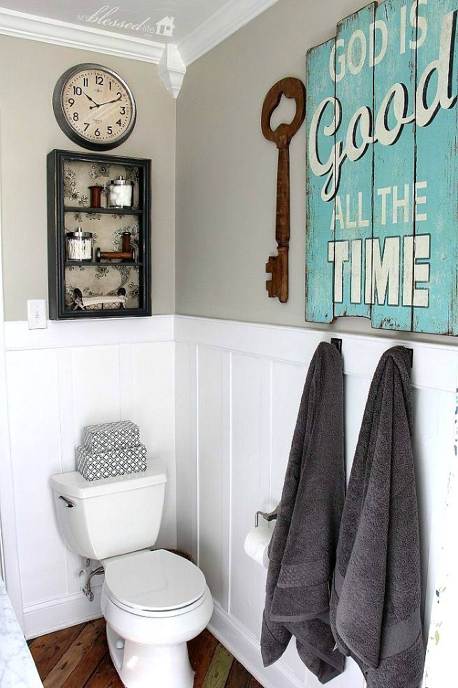 small bathroom with wooden wall sign