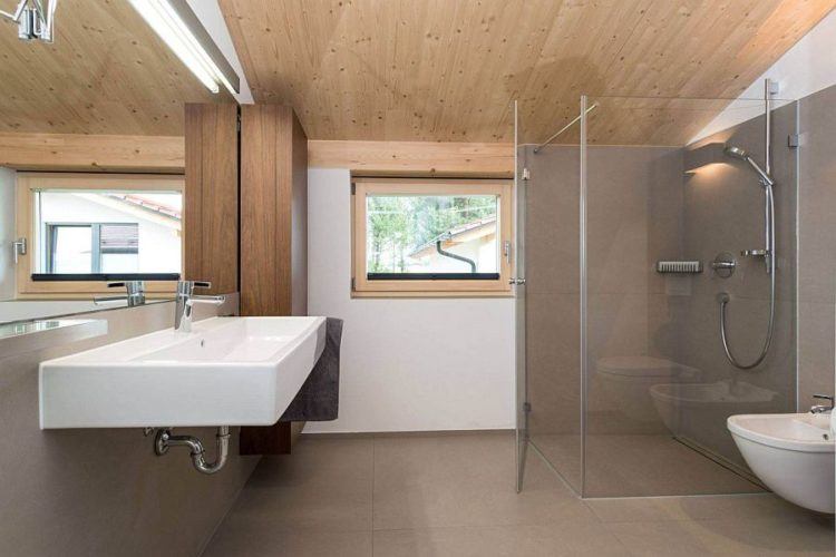 bathroom with floating sink and glass shower