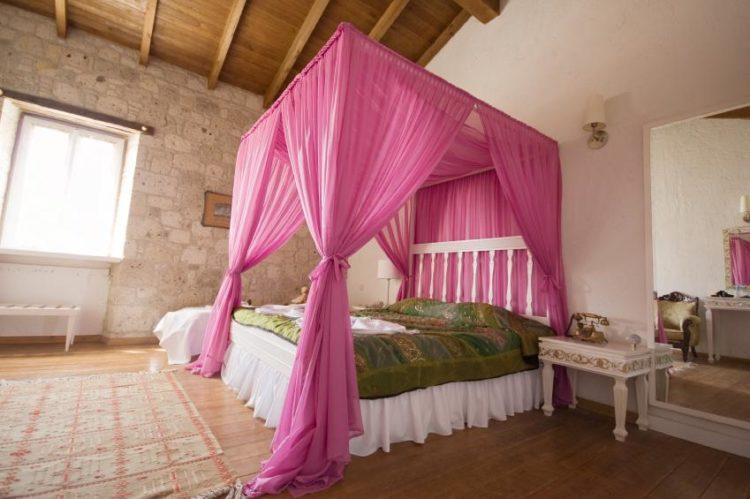 canopy bed with pink curtain