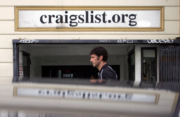 man standing outside of craigslist building