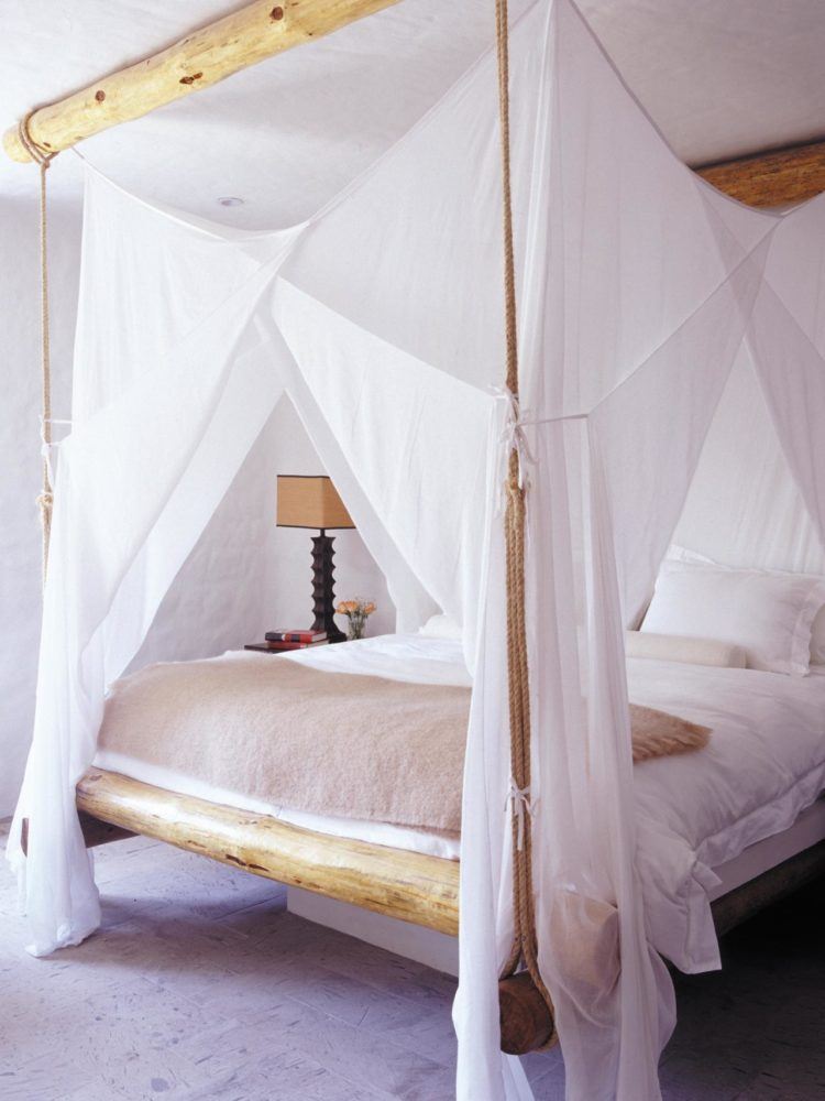 canopy bed with large white droopy curtain