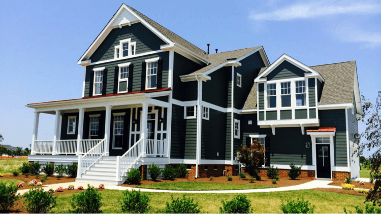 large home with dark exterior and porch